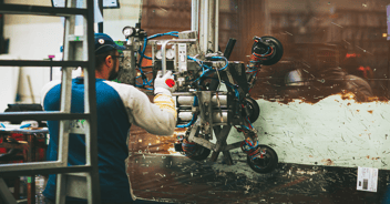 Concentrated worker working in his workshop, surrounded by professional tools and equipment.